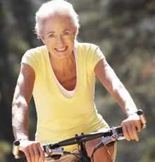 Healthy woman riding on a bike